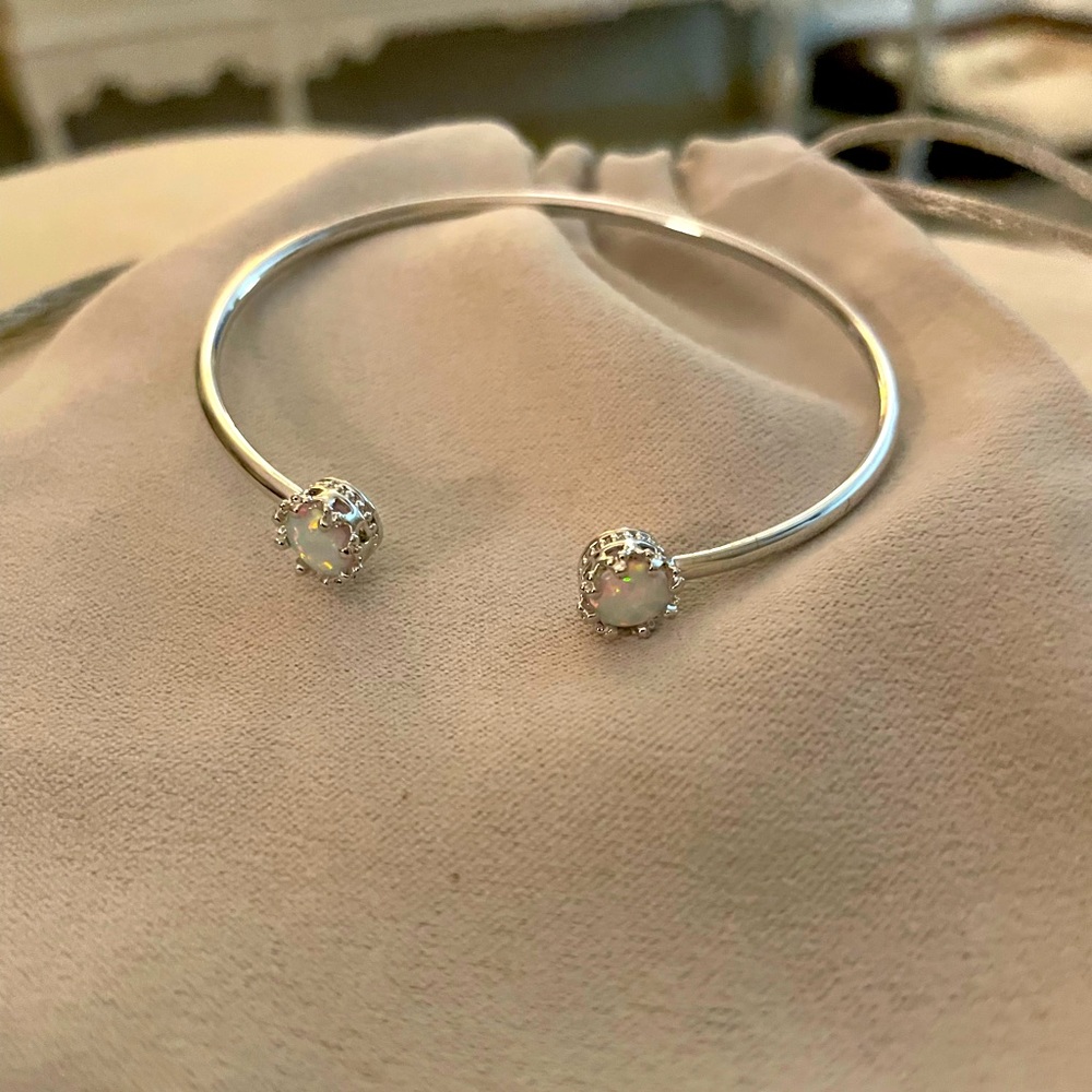 Bangle bracelet with opals in crown settings is a dainty bracelet!